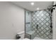 Bathroom with patterned tile shower and built-in bench at 2430 E Palo Verde Dr, Phoenix, AZ 85016