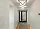 Bright hallway with light wood floors and modern light fixtures at 2430 E Palo Verde Dr, Phoenix, AZ 85016