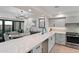 Modern kitchen with gray cabinets, white counters, and stainless steel appliances at 2430 E Palo Verde Dr, Phoenix, AZ 85016