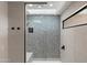 Modern shower with patterned tile and glass enclosure at 2430 E Palo Verde Dr, Phoenix, AZ 85016