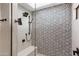 Walk-in shower with patterned tile, built-in seat, and rainfall showerhead at 2430 E Palo Verde Dr, Phoenix, AZ 85016