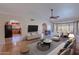 Bright living room with hardwood floors, fireplace, and access to the kitchen and dining area at 2454 W Hearn Rd, Phoenix, AZ 85023