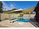 Sparkling pool with shade umbrella and patio furniture at 2454 W Hearn Rd, Phoenix, AZ 85023