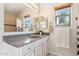 Bathroom features a vanity with granite countertop and large mirror at 24833 W Jessica Ln, Buckeye, AZ 85326