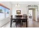 Dining area with a table and four chairs, and view into the bedroom at 24833 W Jessica Ln, Buckeye, AZ 85326