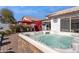 Inviting backyard hot tub with patio furniture under a red umbrella at 24833 W Jessica Ln, Buckeye, AZ 85326