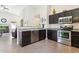 Modern kitchen with stainless steel appliances and dark cabinetry at 24833 W Jessica Ln, Buckeye, AZ 85326