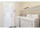 Convenient laundry room with washer, dryer, and overhead shelving at 24833 W Jessica Ln, Buckeye, AZ 85326