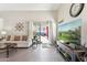 Living room with a sofa, two armchairs and a large screen TV at 24833 W Jessica Ln, Buckeye, AZ 85326