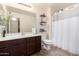 Clean bathroom with dark wood vanity, shower/tub combo, and updated fixtures at 2731 W Wayland Dr, Phoenix, AZ 85041