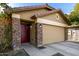 Tan house with a two-car garage and stone accents at 2731 W Wayland Dr, Phoenix, AZ 85041