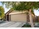 Tan house with a two-car garage and stone accents at 2731 W Wayland Dr, Phoenix, AZ 85041