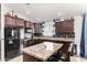 Modern kitchen with granite countertops, dark wood cabinets, and an island at 2731 W Wayland Dr, Phoenix, AZ 85041