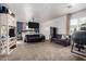 Main bedroom with a king-size bed, two sofas, and a large TV at 2731 W Wayland Dr, Phoenix, AZ 85041