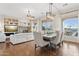 Bright dining room adjacent to the living room with hardwood floors at 28365 N 124Th Dr, Peoria, AZ 85383