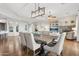 Open dining area with a large wooden table and neutral decor at 28365 N 124Th Dr, Peoria, AZ 85383