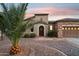 Front view of the home, featuring a charming arched entryway at 28365 N 124Th Dr, Peoria, AZ 85383