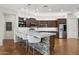 Modern kitchen featuring a large island with seating, stainless steel appliances, and hardwood floors at 28365 N 124Th Dr, Peoria, AZ 85383