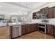 Kitchen features stainless steel appliances, an island, and views into the living room at 28365 N 124Th Dr, Peoria, AZ 85383