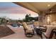 Spacious patio with fire pit, seating, and pool views at 28365 N 124Th Dr, Peoria, AZ 85383