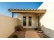 Covered entryway with a green door, two windows, and potted plants at 2916 S Price Rd, Tempe, AZ 85282