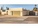 Tan colored garage with a modern home exterior at 2916 S Price Rd, Tempe, AZ 85282