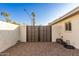 Backyard access with a modern, dark brown gate at 2916 S Price Rd, Tempe, AZ 85282