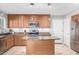 Spacious kitchen with island, stainless steel appliances, and wood cabinets at 2916 S Price Rd, Tempe, AZ 85282