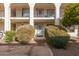 Exterior view of condo building with unit entrance and landscaping at 3270 S Goldfield Rd # 203, Apache Junction, AZ 85119