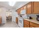 Kitchen with wood cabinets, white appliances, and tile floors at 3270 S Goldfield Rd # 203, Apache Junction, AZ 85119