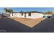 Gravel backyard with patio and small fence at 3301 E Larkspur Dr, Phoenix, AZ 85032