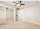 Mirrored closet and ceiling fan in bedroom at 3301 E Larkspur Dr, Phoenix, AZ 85032