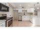 Modern kitchen featuring white cabinets and quartz countertops at 3301 E Larkspur Dr, Phoenix, AZ 85032