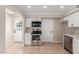 Stainless steel appliances and white cabinetry in this kitchen at 3301 E Larkspur Dr, Phoenix, AZ 85032