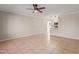 Open concept living room with tile floors, ceiling fan, and kitchen view at 3301 E Larkspur Dr, Phoenix, AZ 85032