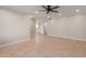 Spacious living room with tile floors and ceiling fan; open to kitchen at 3301 E Larkspur Dr, Phoenix, AZ 85032