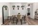 Dining area with a light wood table, neutral chairs, and a brick accent wall at 3302 N 7Th St # 133, Phoenix, AZ 85014