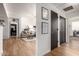 Hallway with light wood floors, offering views into living areas at 3302 N 7Th St # 133, Phoenix, AZ 85014