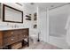 Clean bathroom with white tub, wood vanity, and shelves at 3302 N 7Th St # 366, Phoenix, AZ 85014