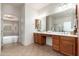 Well-lit bathroom featuring a double sink vanity and plenty of storage space at 33612 N 24Th Dr, Phoenix, AZ 85085