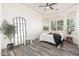 Bright bedroom features wood-look floors, a ceiling fan, and plenty of natural light at 33612 N 24Th Dr, Phoenix, AZ 85085