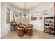 Bright breakfast nook with glass-top table and wicker chairs at 33612 N 24Th Dr, Phoenix, AZ 85085