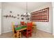 Dining area with rustic wooden table and colorful chairs at 33612 N 24Th Dr, Phoenix, AZ 85085