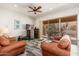 Living room with leather sofas and sliding glass doors at 33612 N 24Th Dr, Phoenix, AZ 85085