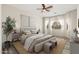 Cozy main bedroom with a ceiling fan, neutral color palette, and plush bedding at 33612 N 24Th Dr, Phoenix, AZ 85085