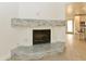 Modern fireplace with stone surround in living room at 3554 W Royal Palm Rd, Phoenix, AZ 85051