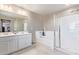 Elegant bathroom with double vanity, bathtub, and walk-in shower at 36811 N El Morro Trl, San Tan Valley, AZ 85140