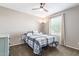 Bright bedroom with a plaid comforter, ceiling fan, and ample natural light at 36811 N El Morro Trl, San Tan Valley, AZ 85140