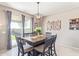 Dining area with a wood table, six chairs, and access to the backyard at 36811 N El Morro Trl, San Tan Valley, AZ 85140