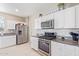 Modern kitchen with stainless steel appliances and granite countertops at 36811 N El Morro Trl, San Tan Valley, AZ 85140